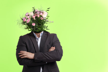 Man with bouquet of flowers instead of his head on light green background, space for text. Creative art collageの写真素材