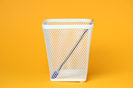One pen in holder on orange backgroundの写真素材