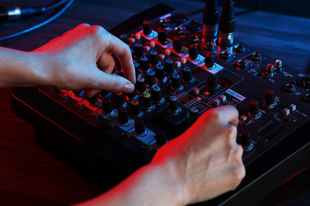Woman working with professional mixing console at table, closeupの写真素材
