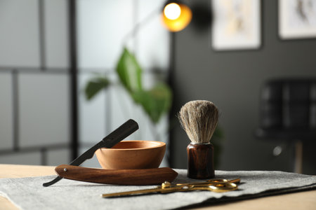 Many different barber's tools on light wooden table in barbershop, closeupの写真素材