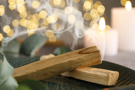 Palo Santo stick smoldering on table, closeupの写真素材