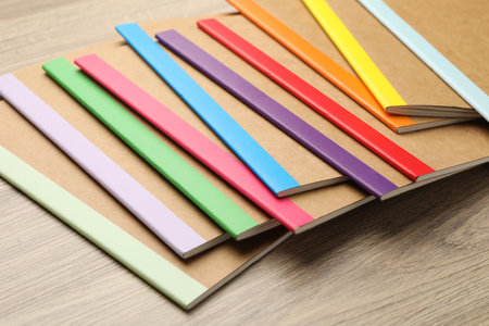 Many different copybooks on wooden table, closeupの写真素材
