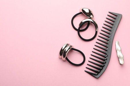 Different hair accessories on pink background, flat lay. Space for textの写真素材