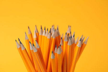 Many pencils on orange background, closeupの写真素材