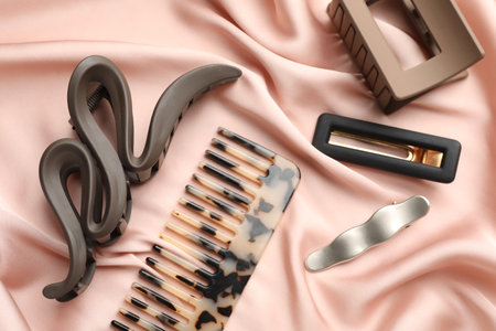 Beautiful hair accessories on pink silk fabric, flat layの写真素材