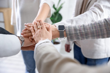 Unity concept. People holding hands together indoors, closeup