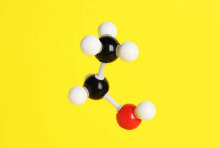 Molecule of ethanol on yellow background. Chemical modelの写真素材