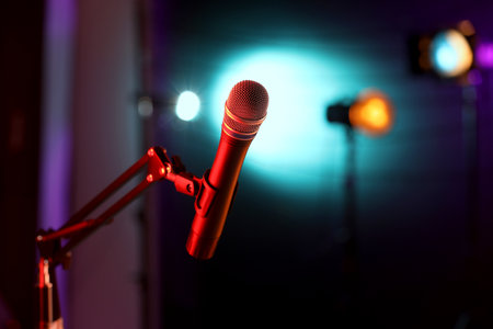 Microphone on stand against color background with blurred lights, space for text. Bokeh effectの写真素材