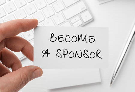 Woman holding business card with text Become A Sponsor at white table, closeupの写真素材