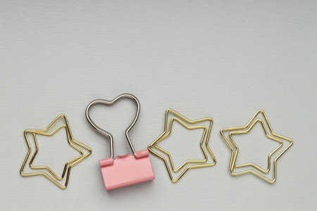 Different paper clips on grey background, flat lay. Space for text