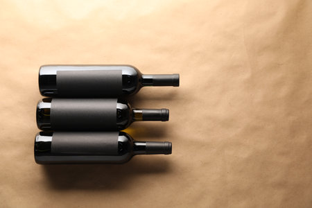 Bottles of wine on parchment paper, flat lay. Space for textの写真素材