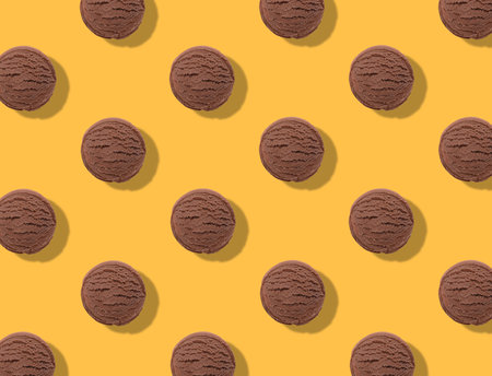 Pattern of chocolate ice cream scoops on orange backgroundの写真素材