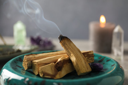 Smoldering palo santo stick and gemstone on table, closeupの写真素材