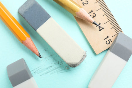Erasers, pencils and ruler on light blue background, flat layの写真素材