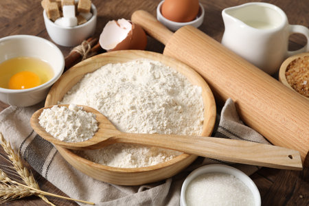Rolling pin and ingredients for dough on wooden table, closeupの写真素材