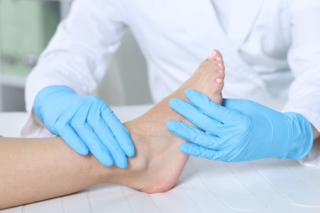 Doctor examining patient's foot in hospital, closeupの写真素材