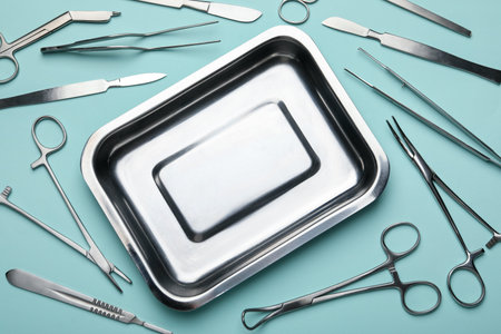 Different surgical tools on turquoise background, flat layの写真素材