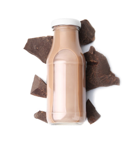 Tasty chocolate milk in glass bottle and pieces of chocolate isolated on white, top viewの写真素材