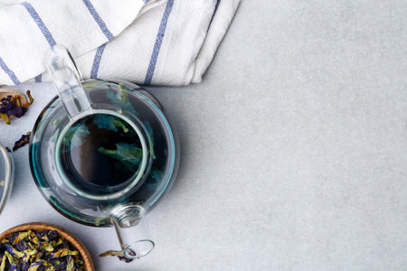 Delicious butterfly pea flower tea on white table, flat lay. Space for textの写真素材