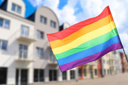 Flag fluttering against building outdoors, low angle viewの写真素材