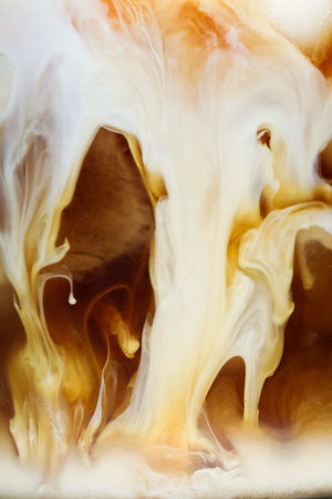 Refreshing coffee with ice and milk as background, closeupの写真素材