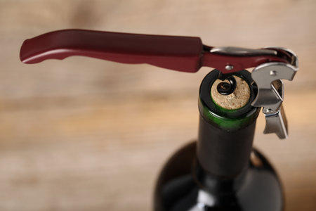 Bottle of luxury wine with corkscrew on blurred background, closeupの写真素材