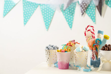 Candy bar. Different yummy sweets on white table indoors. Space for textの写真素材