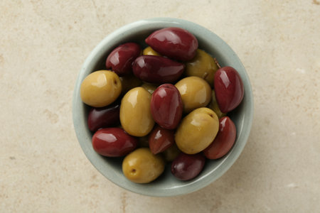 Delicious marinated olives in bowl on grey table, top viewの写真素材