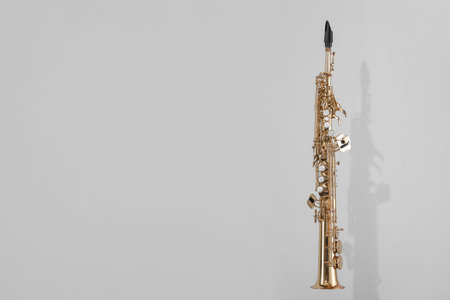 Golden soprano saxophone on light grey background.の写真素材