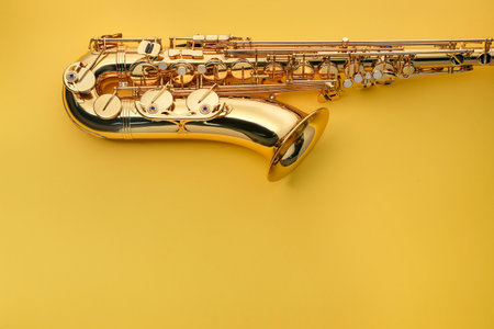 Jazz. One saxophone on yellow background, top view.の写真素材
