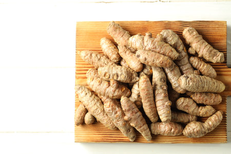 Tumeric rhizomes on white table, top viewの写真素材