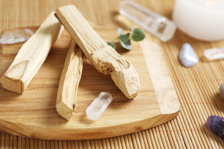 Palo santo sticks and gemstones on wicker table, closeupの写真素材