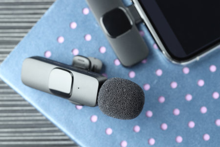 Lavalier microphone, smartphone with wireless receiver and notebook on table, top viewの写真素材