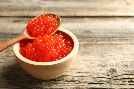 Red caviar on wooden table, closeup.の写真素材