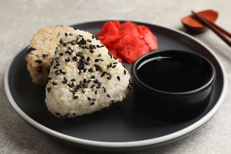Tasty onigiri (Japanese rice balls) served on grey table, closeupの写真素材