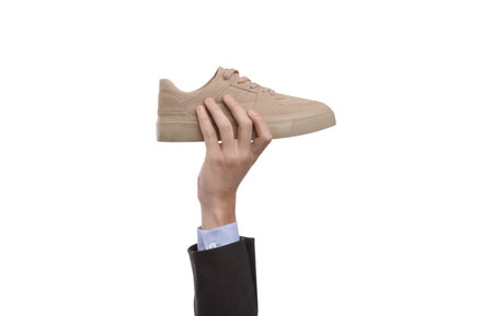 Person holding stylish sneaker on white background, closeupの写真素材