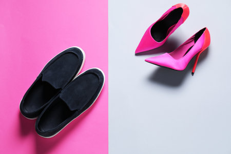 Stylish shoes and high heels on color background, flat layの写真素材