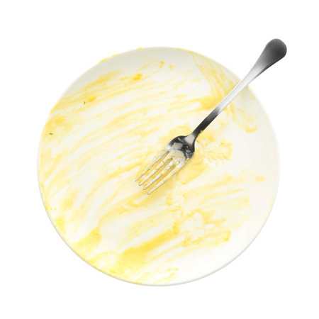 One dirty plate and fork isolated on white, top viewの写真素材