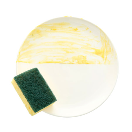 Dirty plate and sponge isolated on white, top viewの写真素材