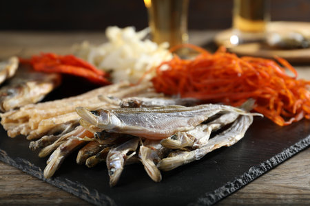 Different dried fish on wooden table, closeupの写真素材