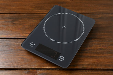 One electronic kitchen scale on wooden table, closeupの写真素材