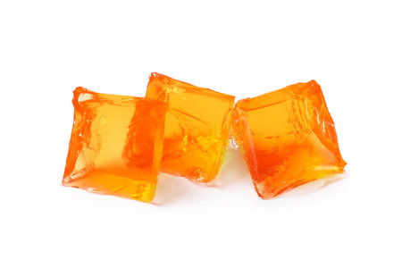 Tasty orange jelly cubes isolated on white, top viewの写真素材