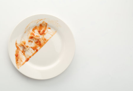 One dirty plate on white background, top view. Space for textの写真素材