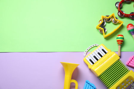 Different toy musical instruments on color background, flat lay. Space for textの写真素材