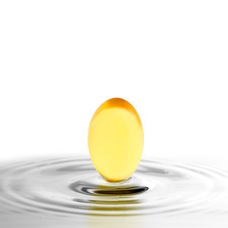 Fish oil capsule in water on white background. Omega-3 fatty acidsの写真素材