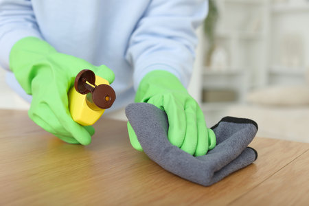 Woman polishing wooden table at home, closeupの写真素材