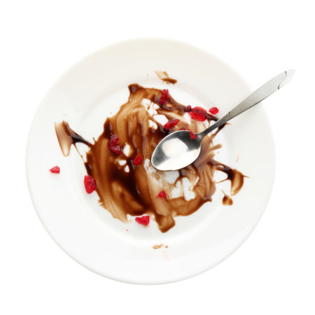 One dirty plate and spoon isolated on white, top viewの写真素材