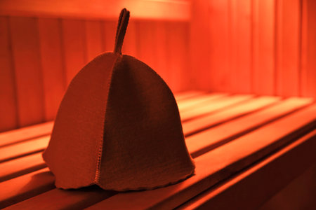 Felt wool hat on wooden bench in sauna. Space for textの写真素材