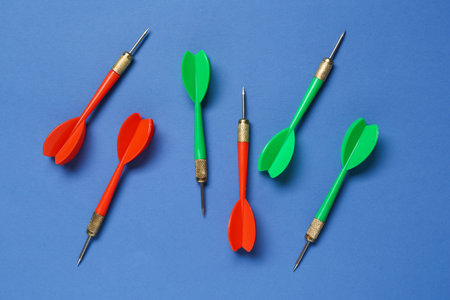 Colorful dart arrows on blue background, flat layの写真素材