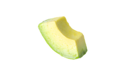 Slice of ripe avocado in air isolated on whiteの写真素材